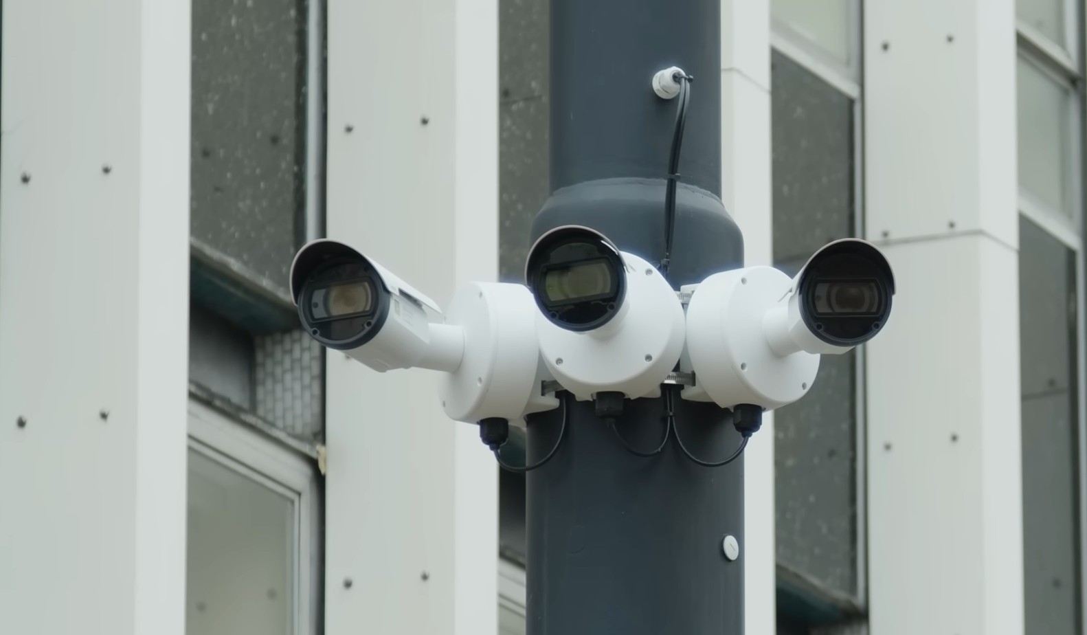 three facial recognition cameras fixed to street furniture